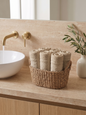 Linoa 450 Hudoo in sand 100% cotton towel, face towel folded in a woven basket