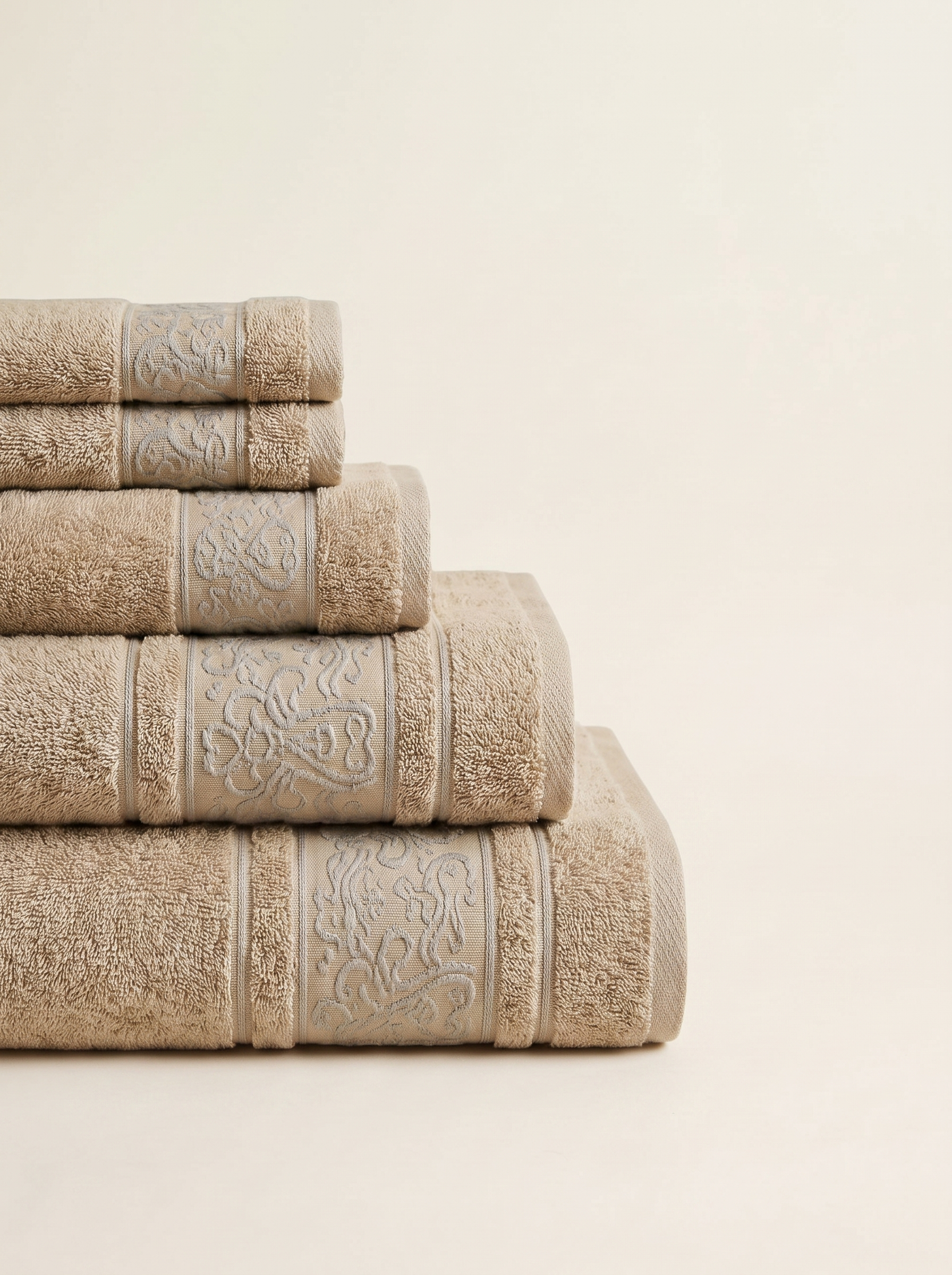 Linoa 450 Hudoo in sand 100% cotton towel, neatly folded stack
