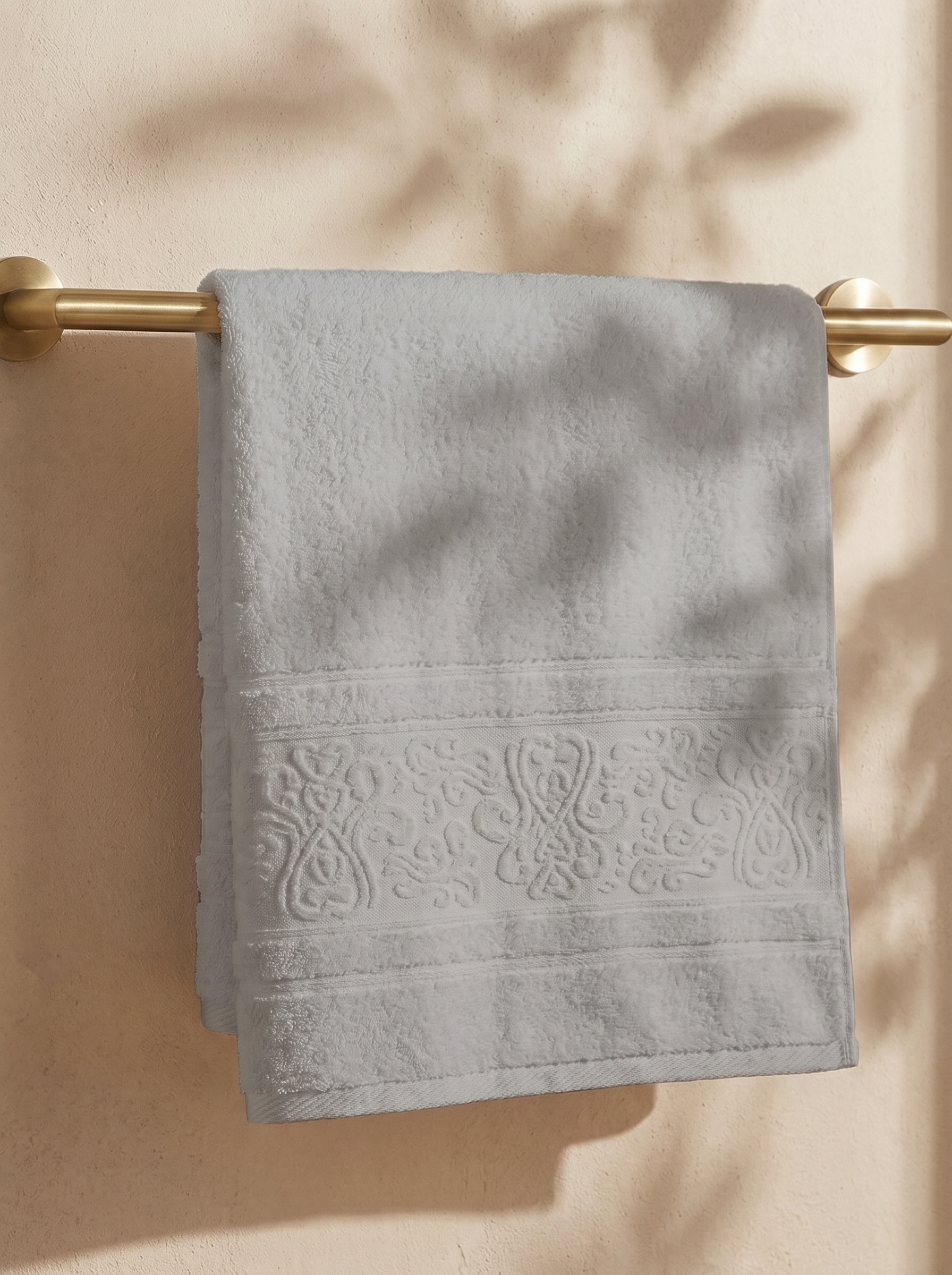 Linoa 450 Hudoo in grey 100% cotton towel, draped over a rail