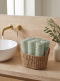 Linoa 450 Hudoo in sage green 100% cotton towel, face towel folded in a woven basket