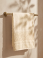 Linoa 450 Hudoo in off-white 100% cotton towel, draped over a rail
