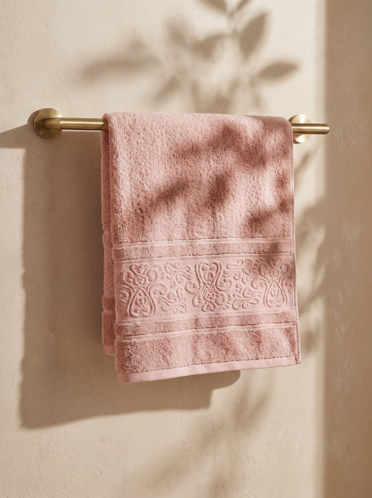 Linoa 450 Hudoo in blush pink 100% cotton towel, draped over a rail