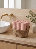 Linoa 450 Hudoo in blush pink 100% cotton towel, face towel folded in a woven basket
