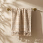 Linoa 450 Sakeena in mocha brown 100% cotton towel, draped over a rail