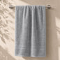 Linoa 550 Naeem in grey 100% cotton towel, draped over a rail