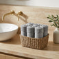 Linoa 550 Naeem in grey 100% cotton towel, face towel folded in a woven basket