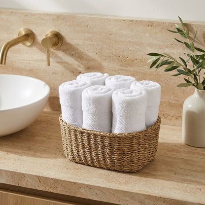 Linoa 550 Naeem in white 100% cotton towel, face towel folded in a woven basket