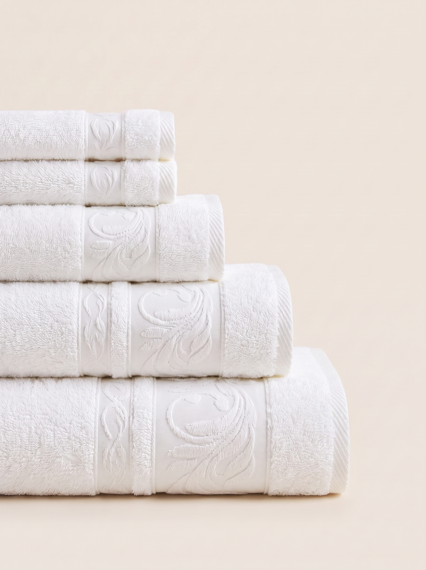 Linoa 550 Reesha Feather in white 100% cotton towel, neatly folded stack