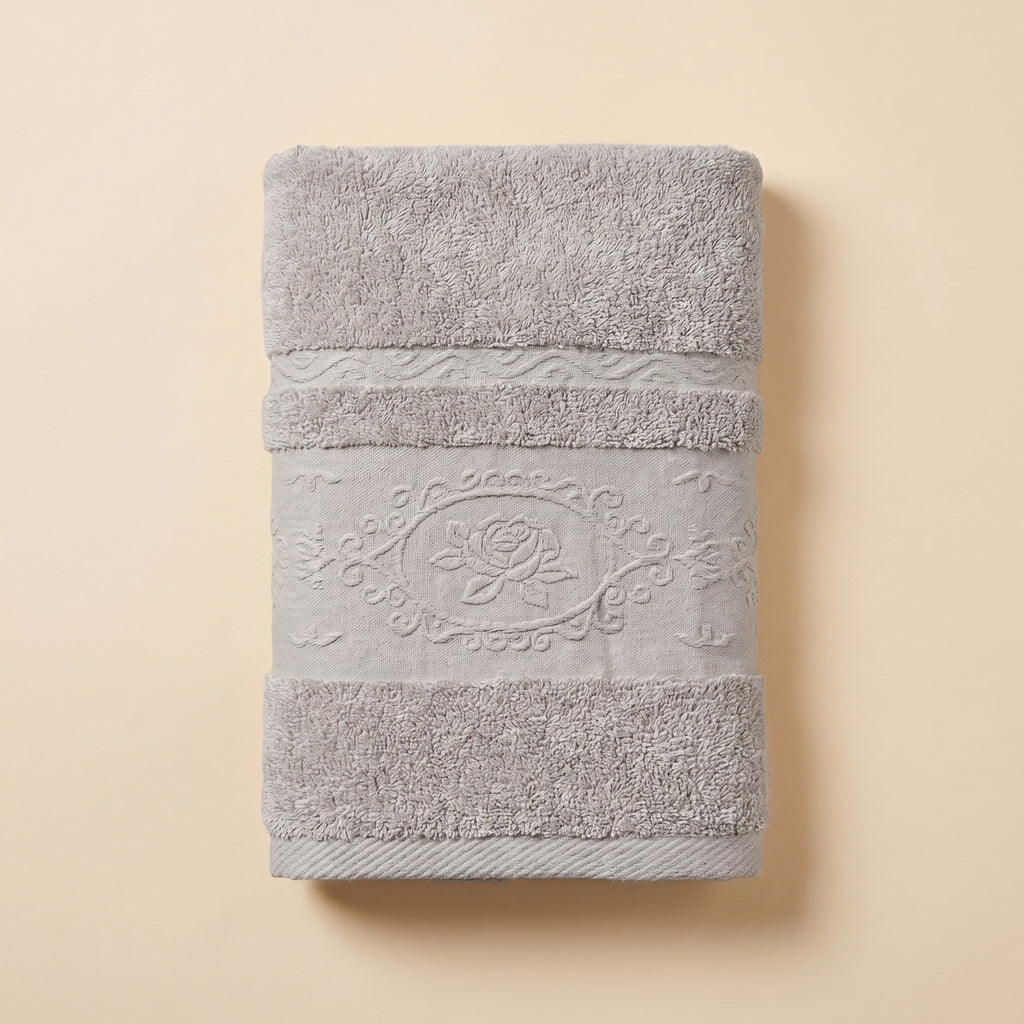 Linoa 650 Fakhm Luxe in grey 100% cotton towel, studio product shot, rose-medallion border