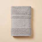 Linoa 650 Fakhm Luxe in grey 100% cotton towel, studio product shot, rose-medallion border