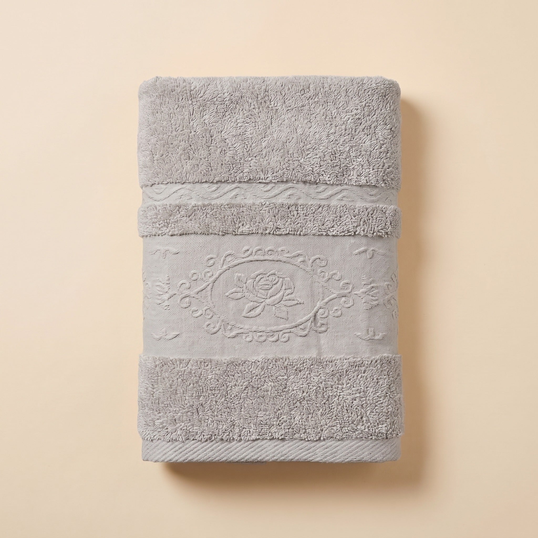 Linoa 650 Fakhm Luxe in grey 100% cotton towel, studio product shot, rose-medallion border