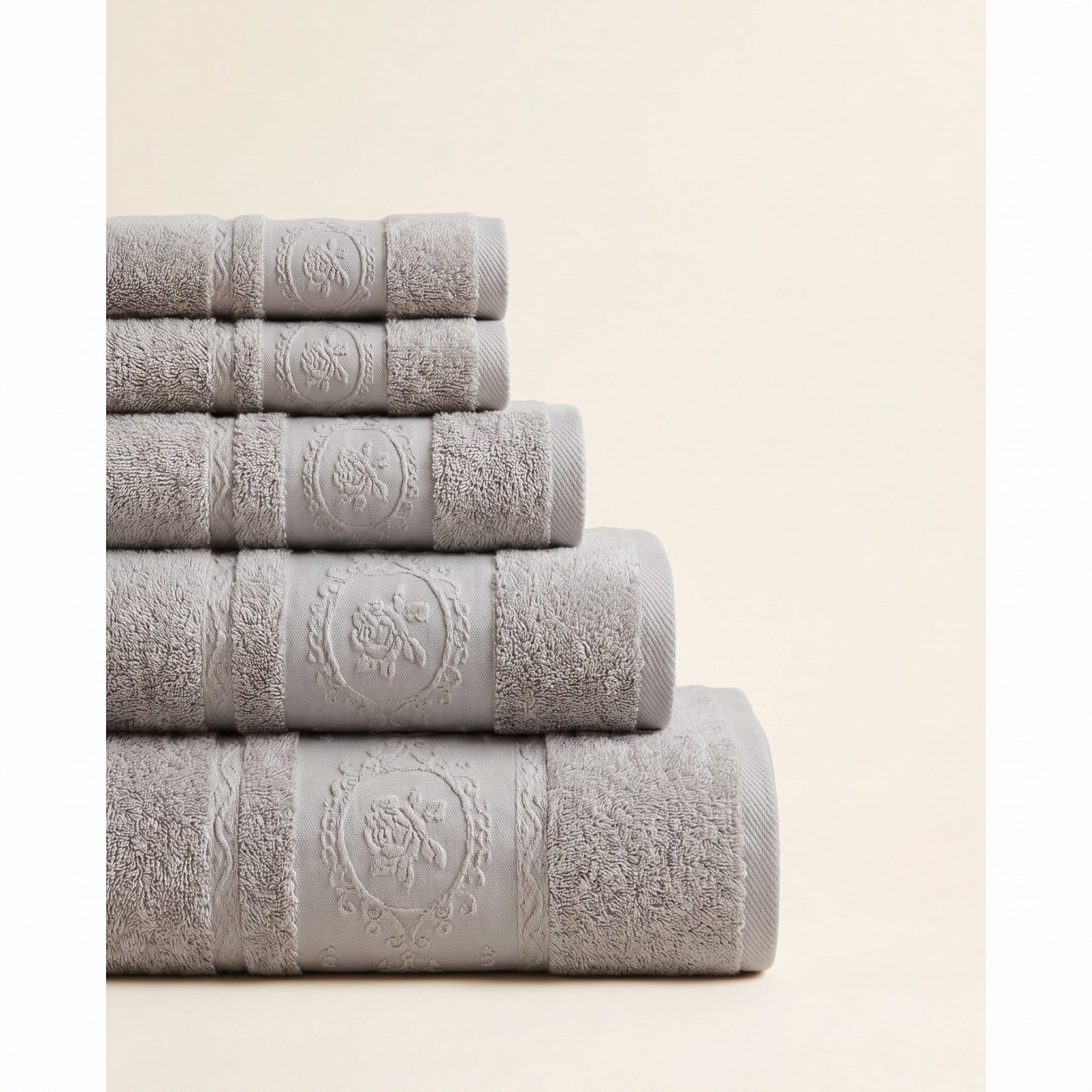 Linoa 650 Fakhm Luxe in grey 100% cotton towel, neatly folded stack, rose-medallion border