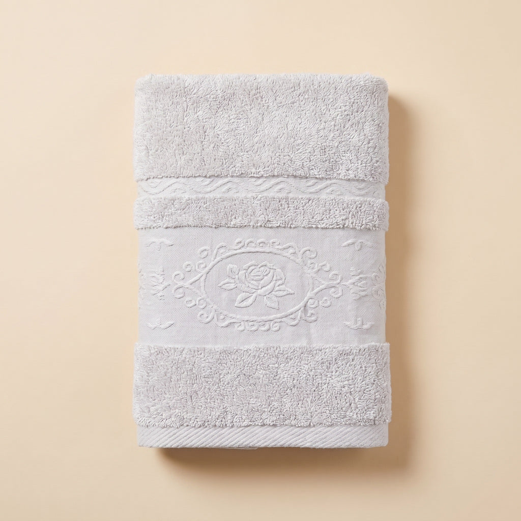Linoa 650 Fakhm Luxe in white 100% cotton towel, studio product shot, rose-medallion border