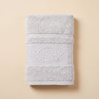 Linoa 650 Fakhm Luxe in white 100% cotton towel, studio product shot, rose-medallion border