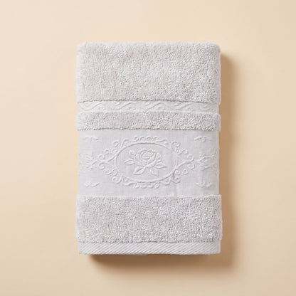 Linoa 650 Fakhm Luxe in white 100% cotton towel, studio product shot, rose-medallion border