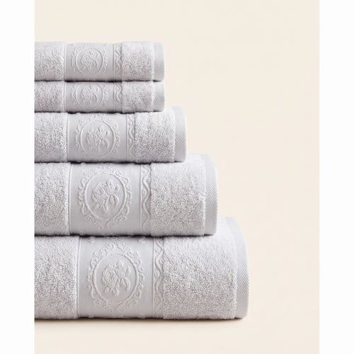 Linoa 650 Fakhm Luxe in white 100% cotton towel, neatly folded stack, rose-medallion border