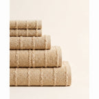 Linoa 650 Naem+ Spa in sand tan 100% cotton towel, neatly folded stack