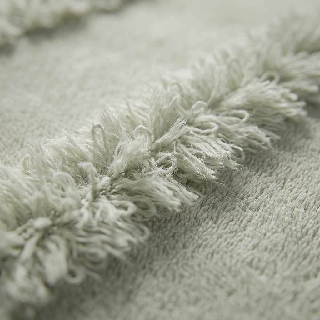 Linoa 650 Naem+ Spa in sage green 100% cotton towel, macro close-up of the raised tufted stripe weave
