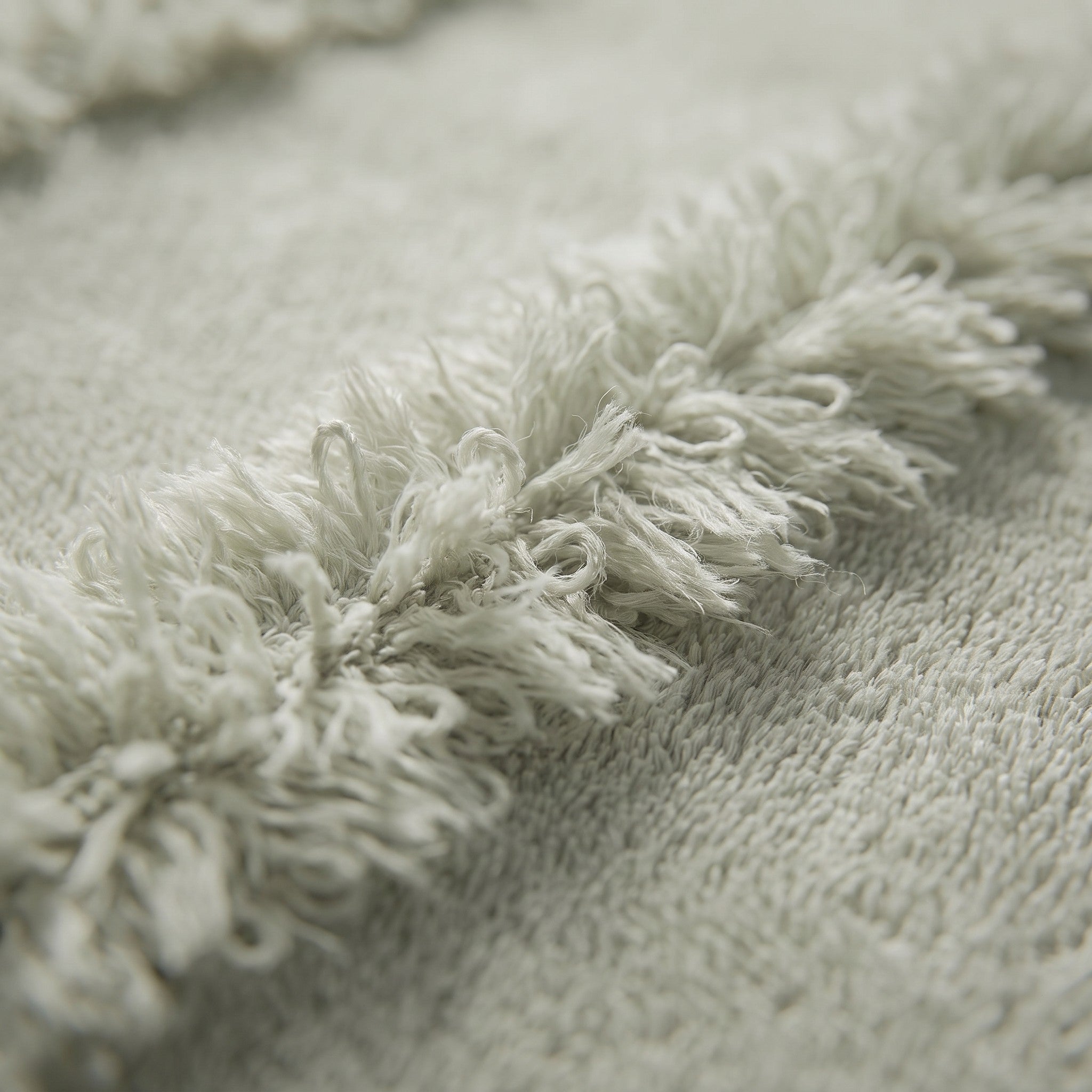 Linoa 650 Naem+ Spa in sage green 100% cotton towel, macro close-up of the raised tufted stripe weave