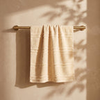 Linoa 650 Naem+ Spa in cream 100% cotton towel, draped over a rail