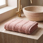 Linoa 650 Naem+ Spa in blush pink 100% cotton towel, folded on a shelf