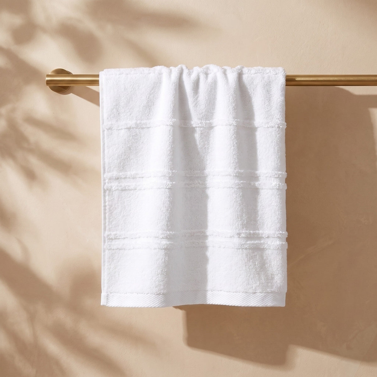 Linoa Naem+ Spa white towel draped, tufted stripe weave