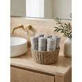 Linoa 650 Sahb in grey 100% cotton towel, face towel folded in a woven basket