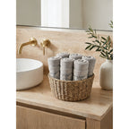 Linoa 650 Sahb in grey 100% cotton towel, face towel folded in a woven basket