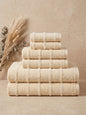 Linoa Signature Naem+ towel set in cream, folded stack, tufted stripe weave