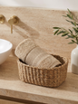 Linoa 550 Naeem in sand 100% cotton towel, face towel folded in a woven basket