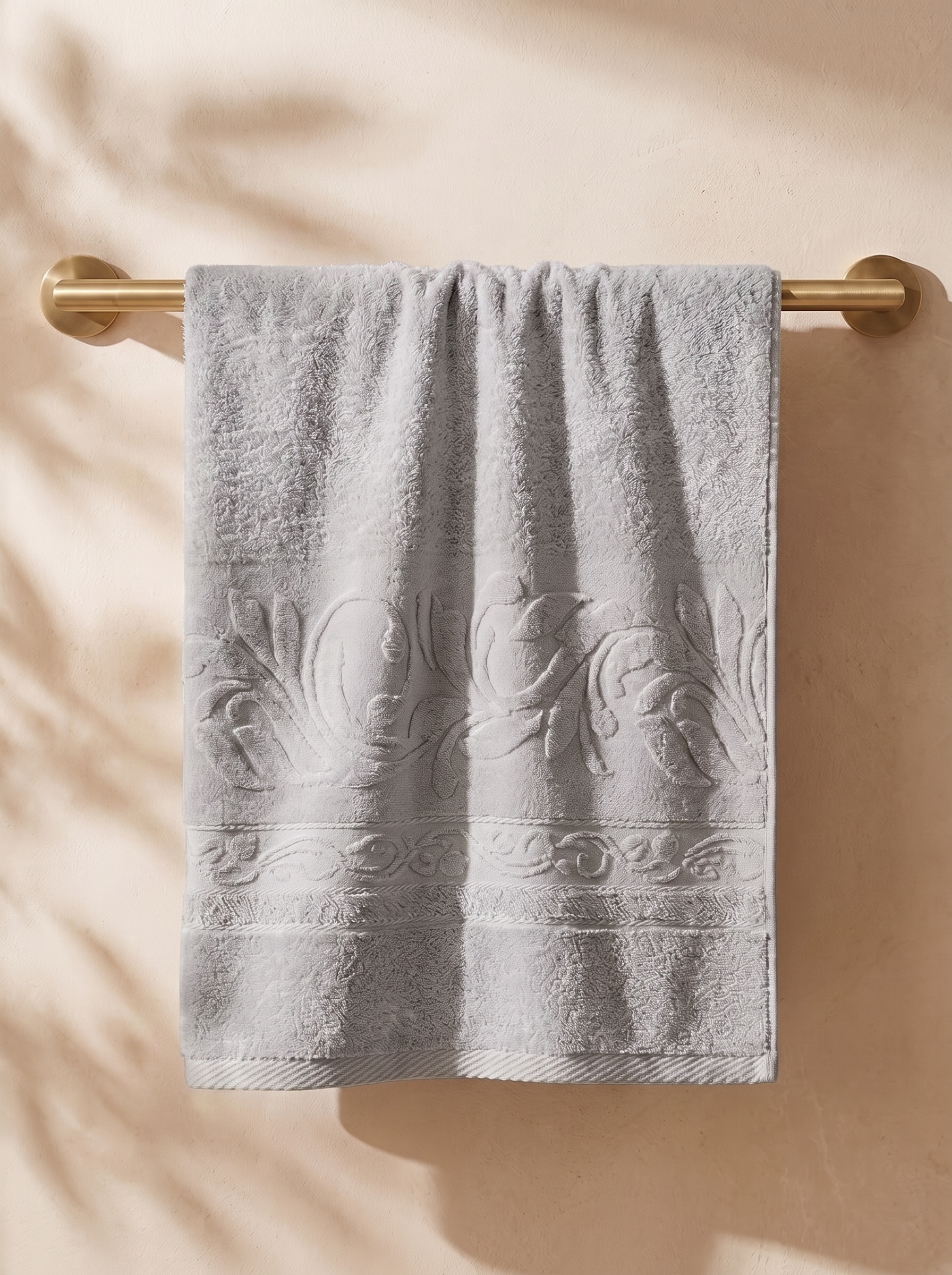 Linoa 550 Reesha Feather in grey 100% cotton towel, draped over a rail